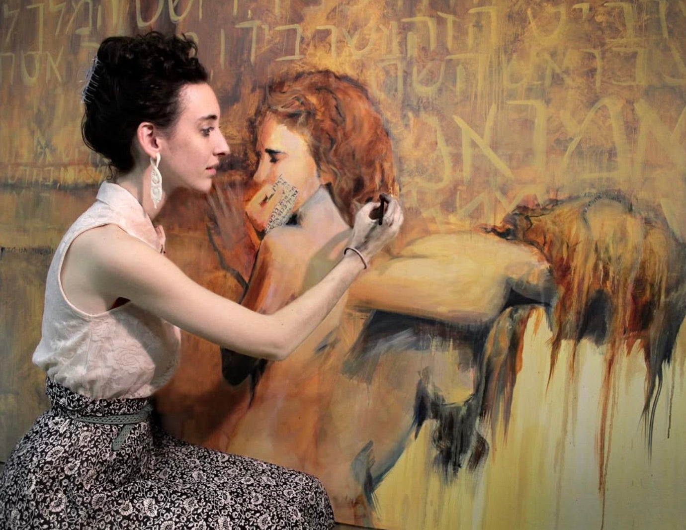 The artist painting a large canvas in the studio